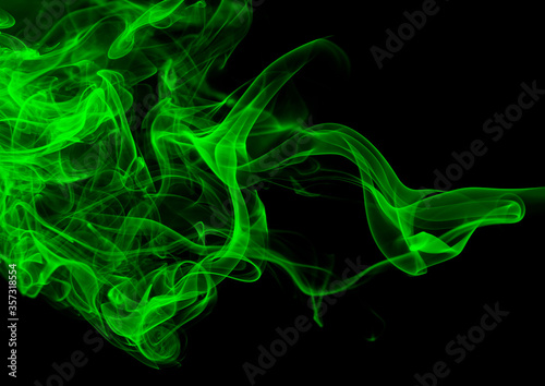 Green smoke abstract on black backgroud for design, darkness concept