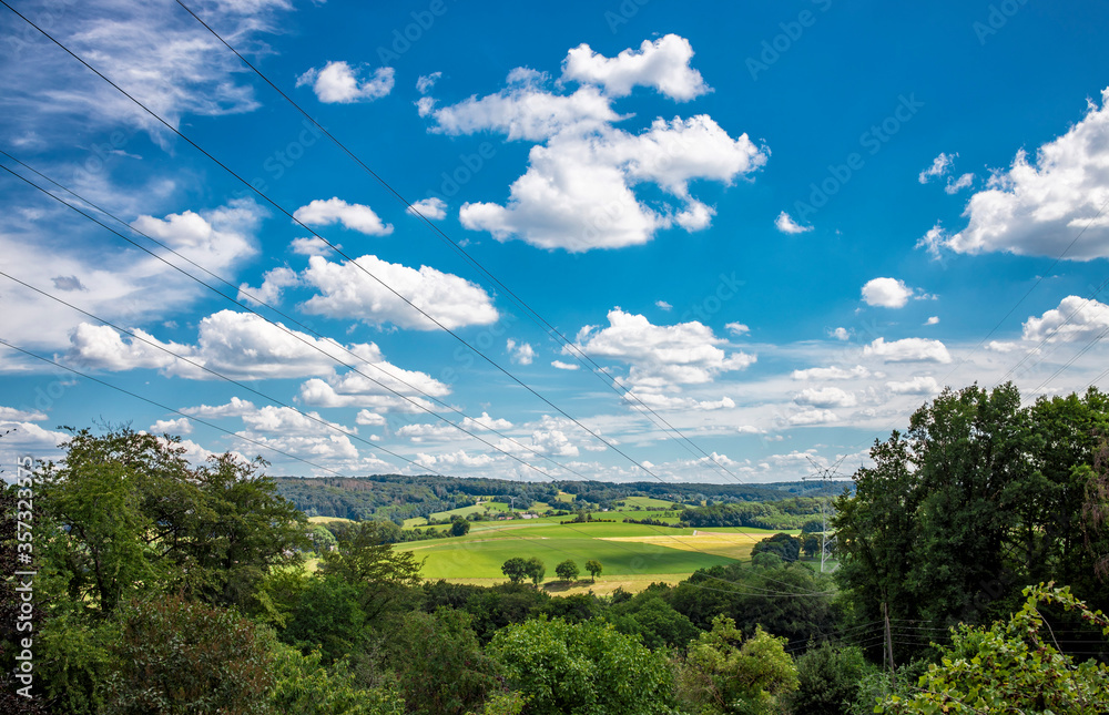 Fototapeta premium German rural landscape near Velbert Langenberg with fields and hills and a Farm in Background