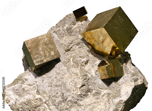 Pyrite cubic crystals embedded in a matrix on white background