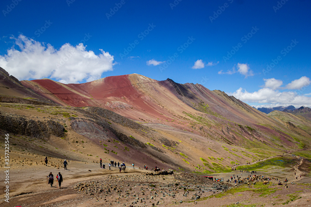 people climbing to reach vinicunca rainbow mountain