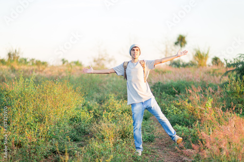Young man happy and having fun in a field