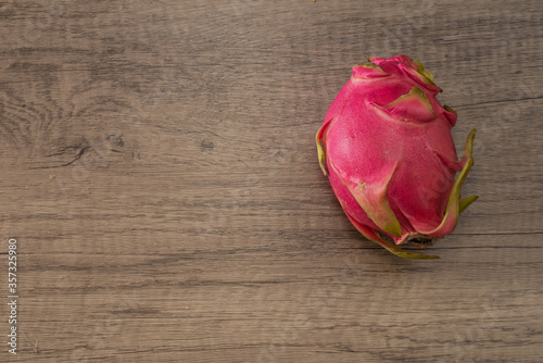 Dragon fruit on old wood background embed path