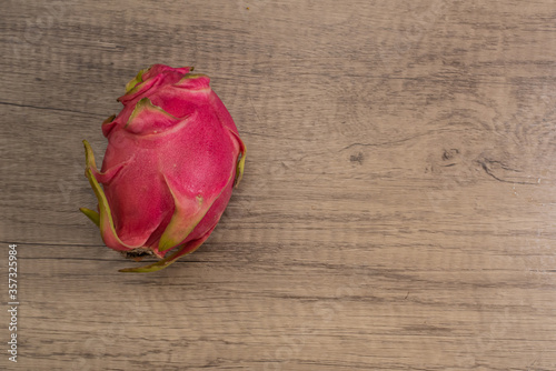 Dragon fruit on old wood background embed path
