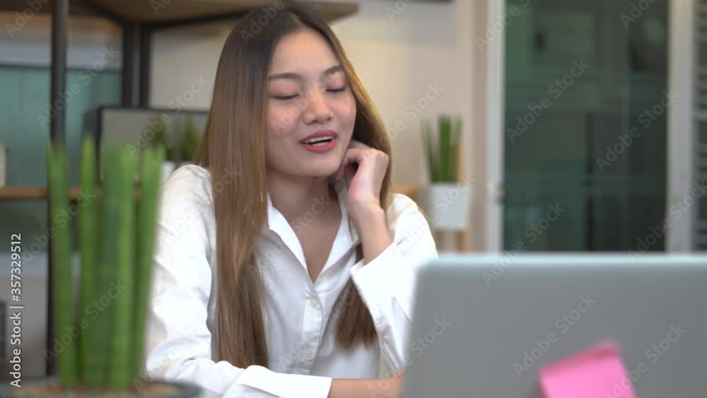 Young beautiful woman works for a computer from a home with a laptop on desk as a freelancer Young beautiful woman works for a computer from a home with a laptop on desk as a freelancer