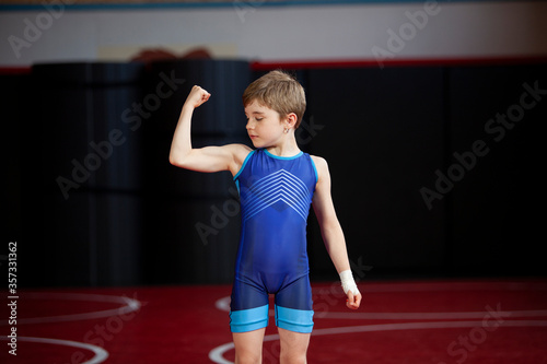 Young female wrestler in a blue singlet