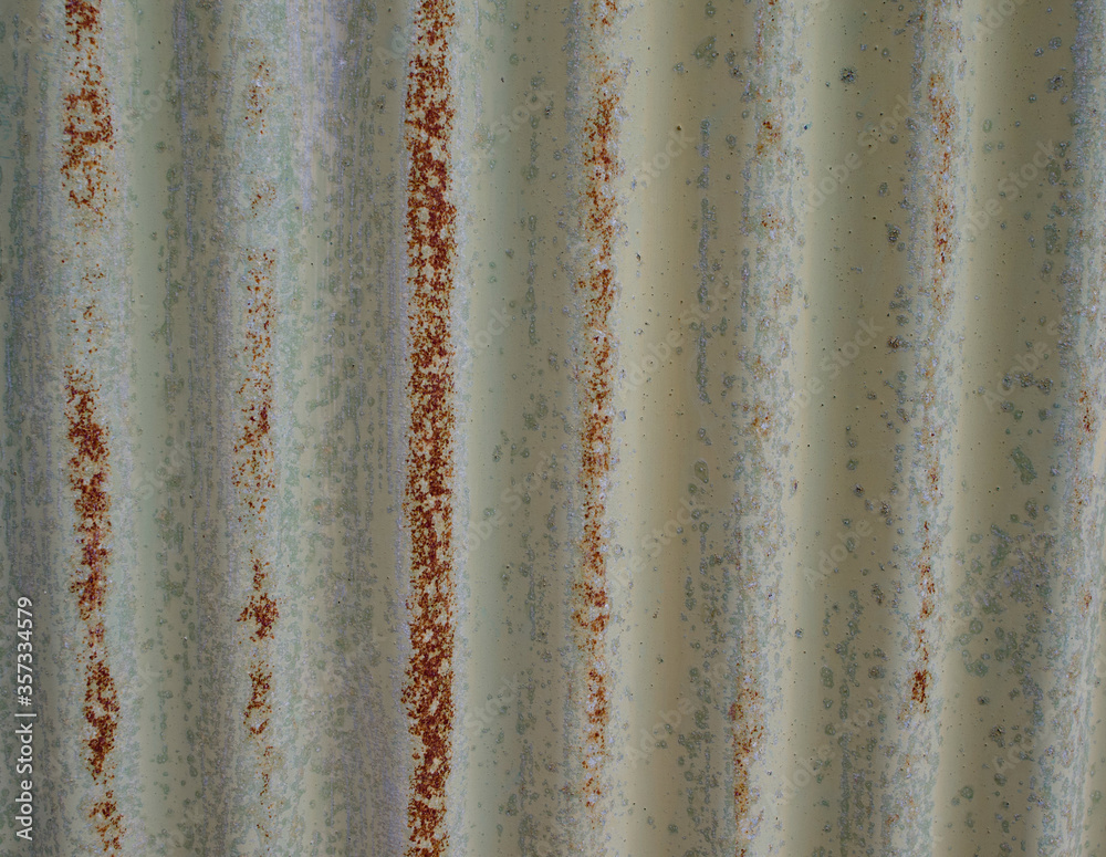 Old weathered corrugated sheet /panel with peeled paint. Background texture of rusty painted corrugated iron cladding Old weathered corrugated sheet /panel with peeled paint. Background texture of rusty painted corrugated iron cladding