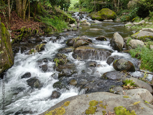 Savegre pristine river with rocks in the forest in Costa Rica