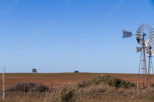 A handmade old windmill in a rural field, Australia