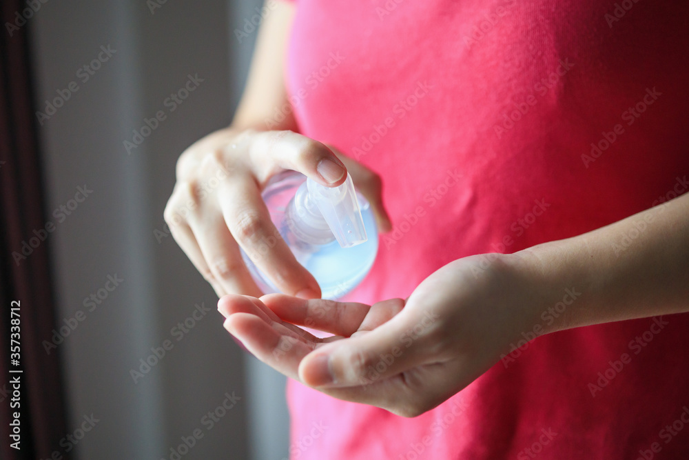 Woman using alcohol sanitizer gel rub for cleaning hand COVID-19 corona virus prevention concept Woman using alcohol sanitizer gel rub for cleaning hand COVID-19 corona virus prevention concept
