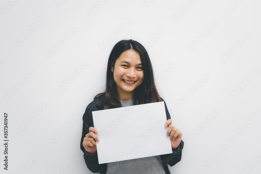 Woman showing blank white paper for copy space Woman showing blank white paper for copy space