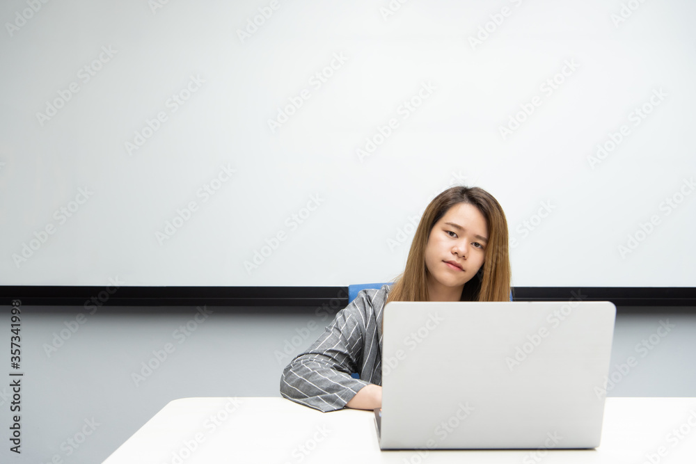 Woman working by laptop in office with happy Woman working by laptop in office with happy