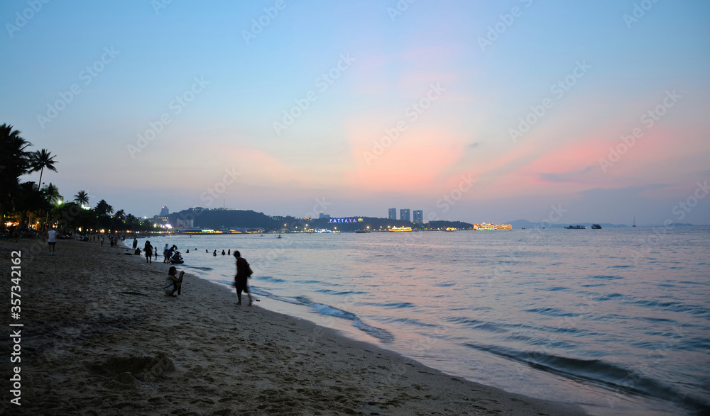 Unidentified People Along Pattaya Beach at Sunset