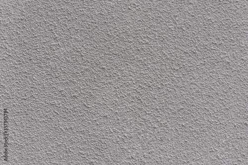 Wall is painted with white plaster with fine texture.