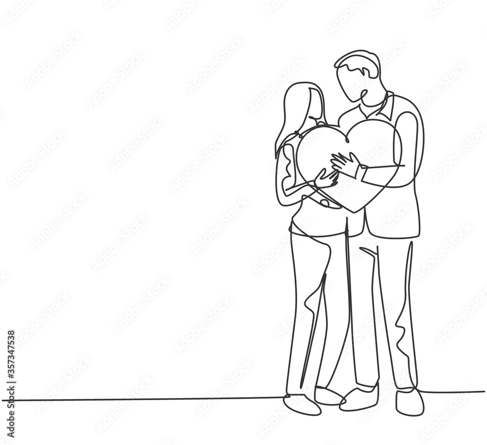 One single line drawing of young happy couple man and woman holding heart shape pillow and smiling each other. Romantic marriage love concept continuous line draw design graphic vector illustration