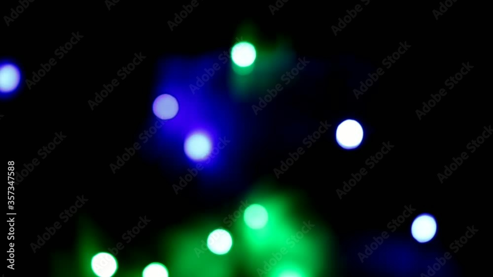Out of focus flashing color lights at Christmas night, soft defocused