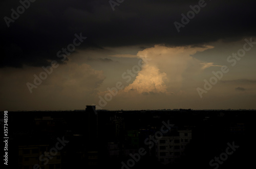 Dramatic & Colorful sunset sky from an above building after rain. sunset panorama with raspberry clouds over a small town against a blue sky. Cityscape and landscape beauty.  © ArAfAt114