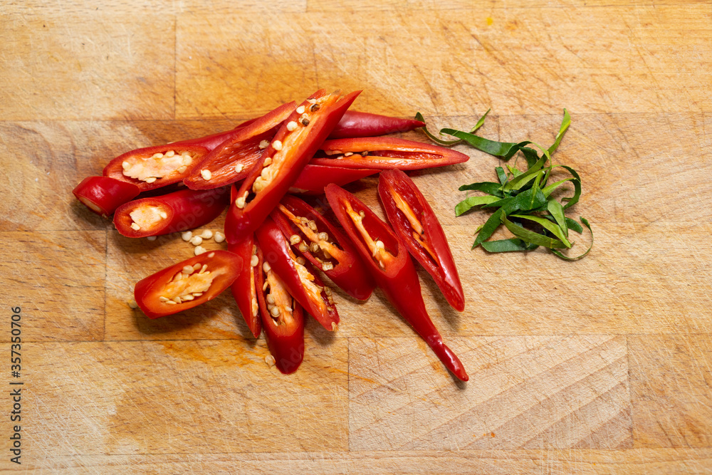 Sliced red chili on the wooden background Sliced red chili on the wooden background