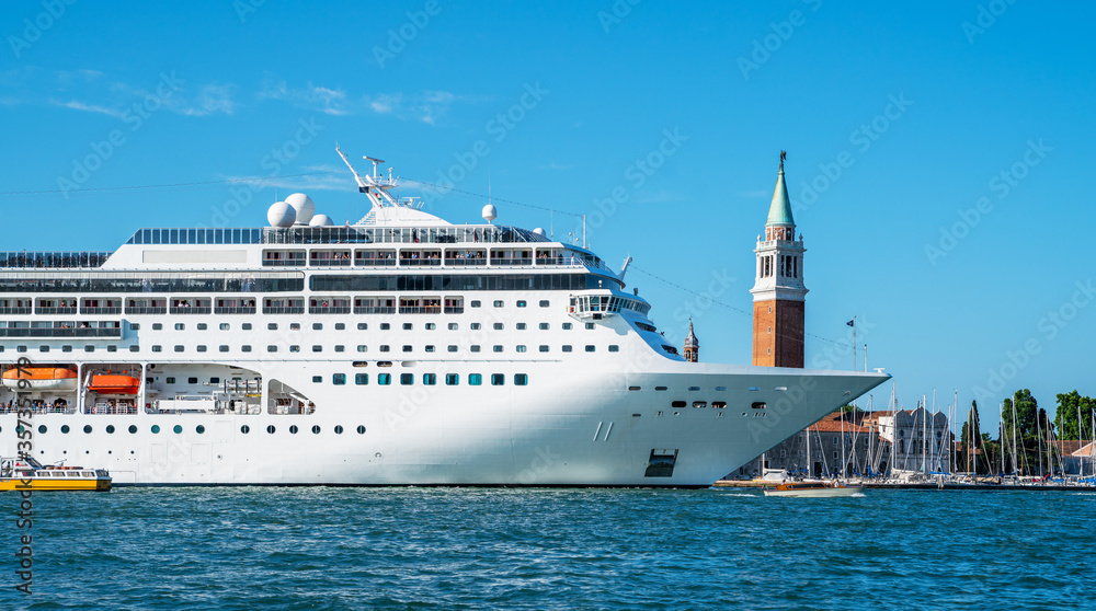 Oversized cruise ship brings thousands of tourists to Venice, italy.