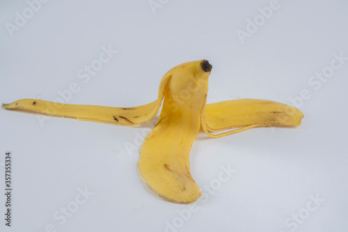 The skin of a yellow banana on a white background photo