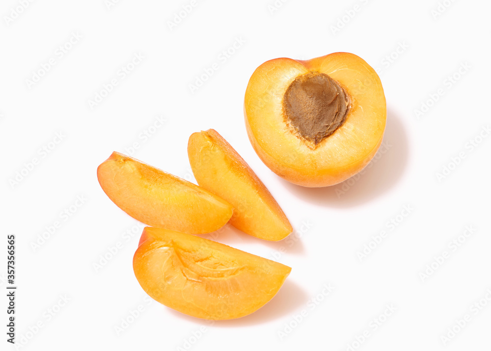 fresh ripe whole, half and sliced apricot, close view, white background fresh ripe whole, half and sliced apricot, close view, white background