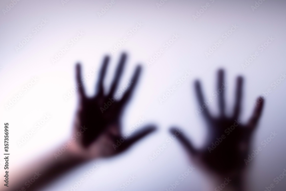 Blurred silhouette of hands and the inscription for stop . Blurred silhouette of hands and the inscription for stop .
