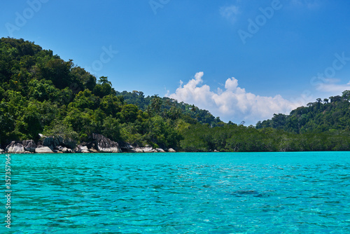 Landscape of the line of the rainforest on the ocean. Tropical island in Indian Ocean. Uninhabited isle with palm trees. Paradise island. Perfect getaway. Travel, vacantion concept. 