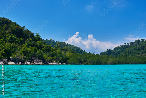 Landscape of the line of the rainforest on the ocean. Tropical island in Indian Ocean. Uninhabited isle with palm trees. Paradise island. Perfect getaway. Travel, vacantion concept.   © eskstock