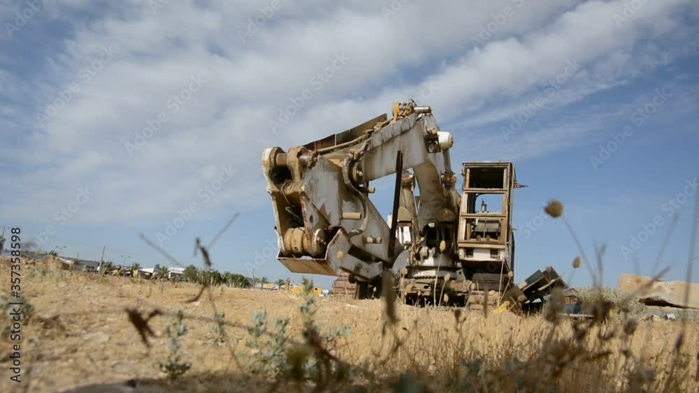abandoned excavator. rusted parts in the sunset light. post-apocalyptic concept. abandoned excavator. rusted parts in the sunset light. post-apocalyptic concept.