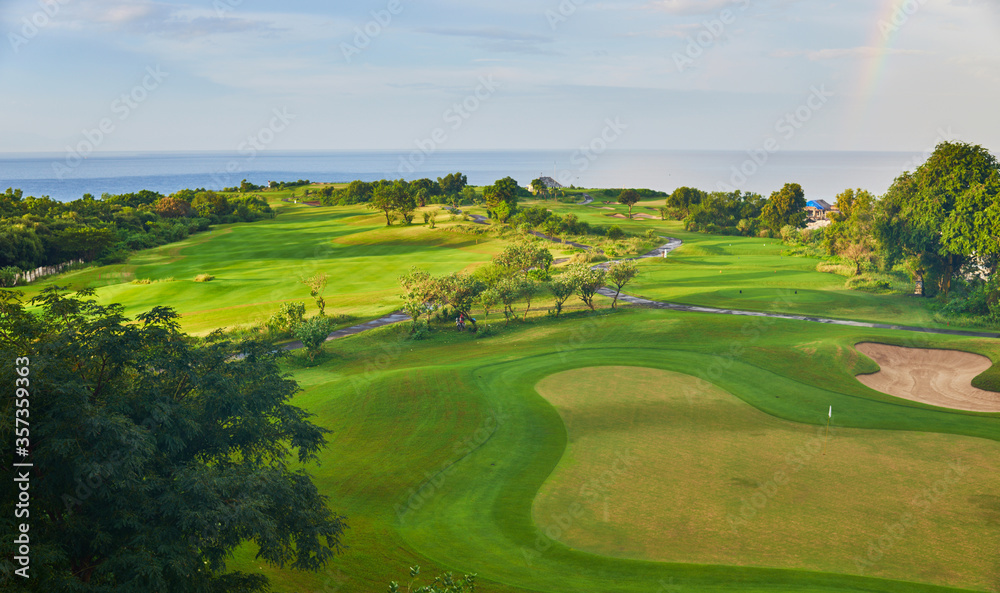 View of golf course with green grass. Golf course with a rich green turf beautiful scenery. Stunning view of a coastal golf course. Golf place with wonderful green.