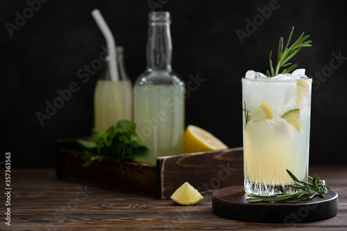 glass with freshly squeezed lemonade with ice, fresh lemons and mint