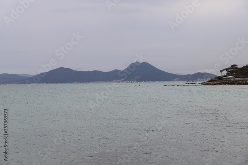 The Sea with Mountains in the Distance