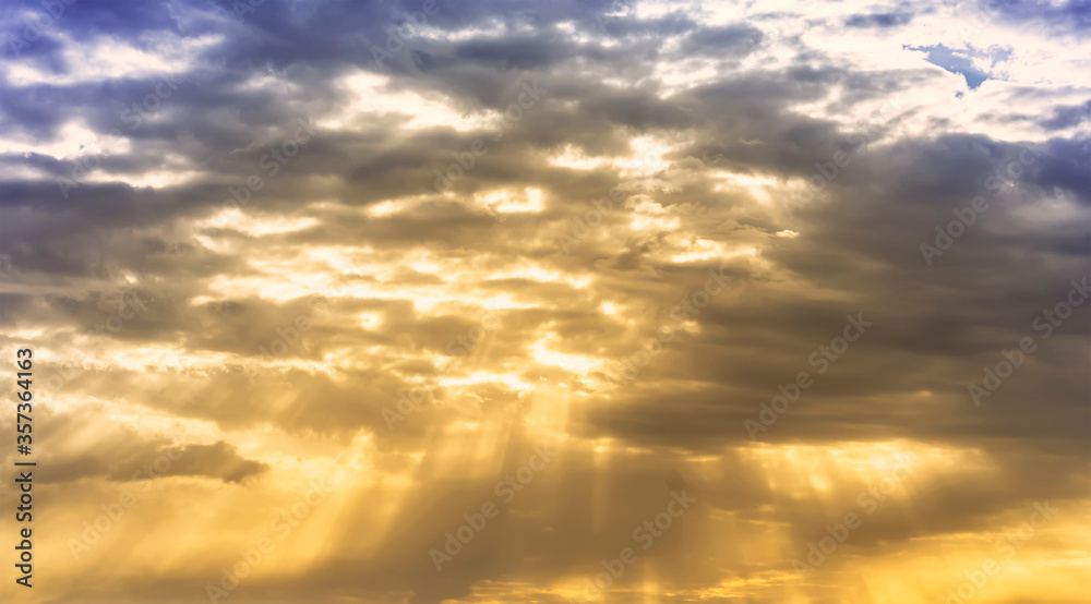 evening cloudy sky with mild golden light , shinig through the colored orange clouds , nature landscape background evening cloudy sky with mild golden light , shinig through the colored orange clouds , nature landscape background