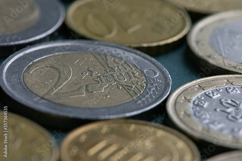 A few cents in close-up. On the table is a coin of two euros and a few cents in close-up. Selective focus.