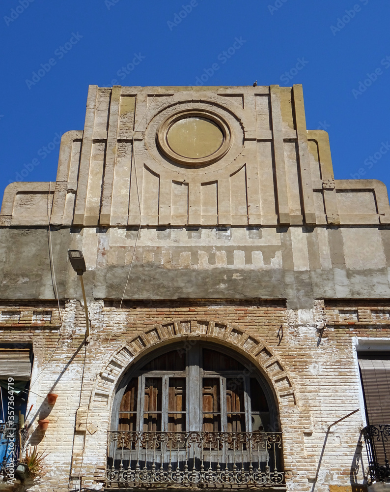 Art deco building with balconies and beautiful decorated pediment. Cabanyal Quarter in the city of Valencia. Spain. 