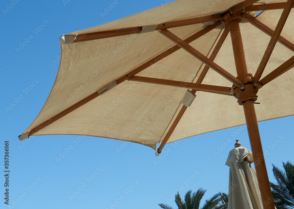 beach umbrellas against the blue sky