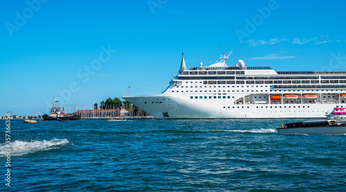 Oversized cruise ship brings thousands of tourists to Venice, italy.