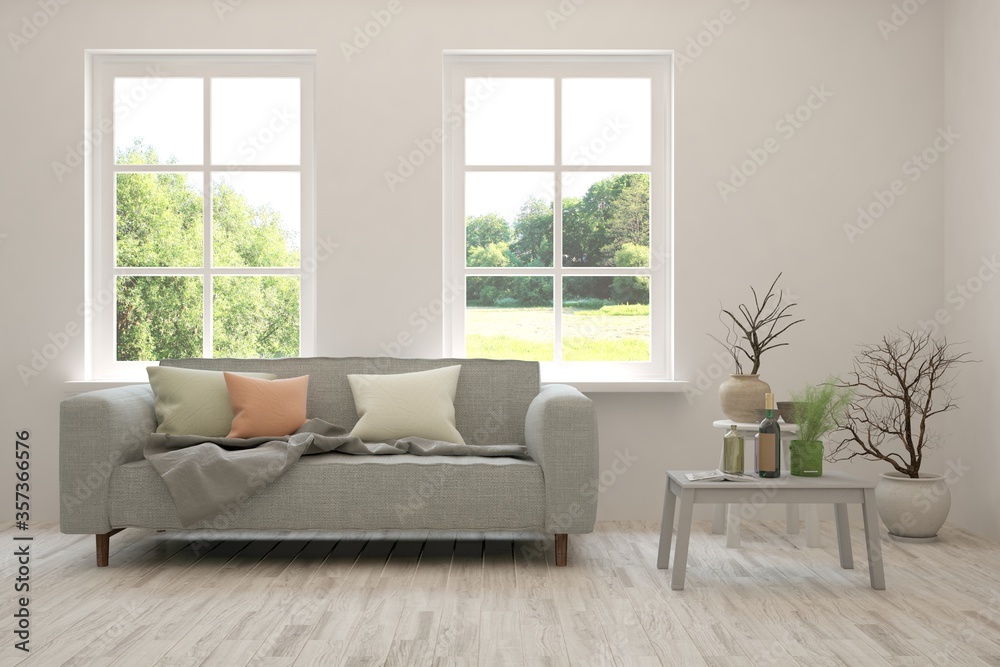 Fototapeta premium White living room with sofa and summer landscape in window. Scandinavian interior design. 3D illustration