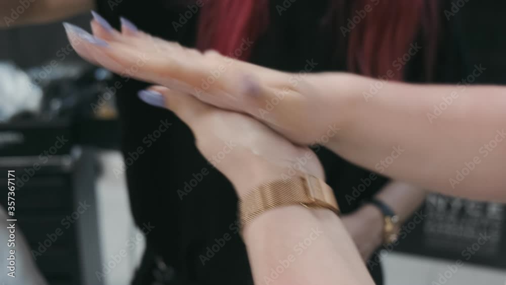 Stylist rubs the gel in his hands. Barber styling his client hair using a gel Stylist rubs the gel in his hands. Barber styling his client hair using a gel