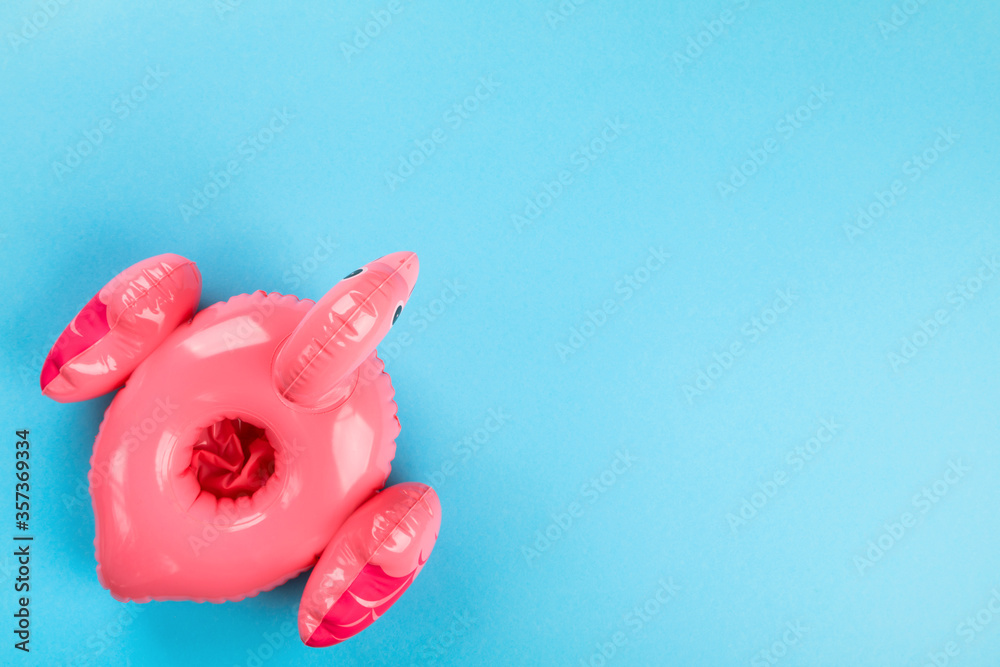 Inflatable Flamingo on blue background.Trendy summer concept.Beach composition.