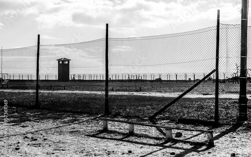 Fotografie, Tablou Grayscale shot of a concentration camp behind the fence