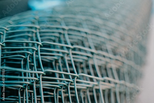 Fototapeta Naklejka Na Ścianę i Meble -  Close up shot of silver blue badger fences put together creating a sense of 3d