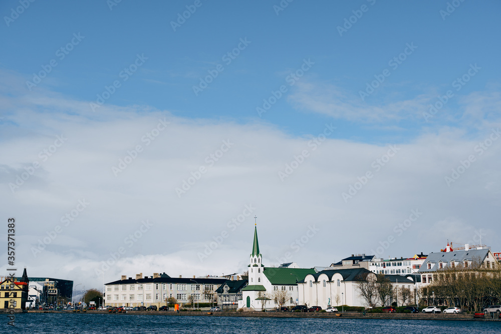 Buildings on the shore of Lake Tjodnin, in Reykjavik, the capital of Iceland.