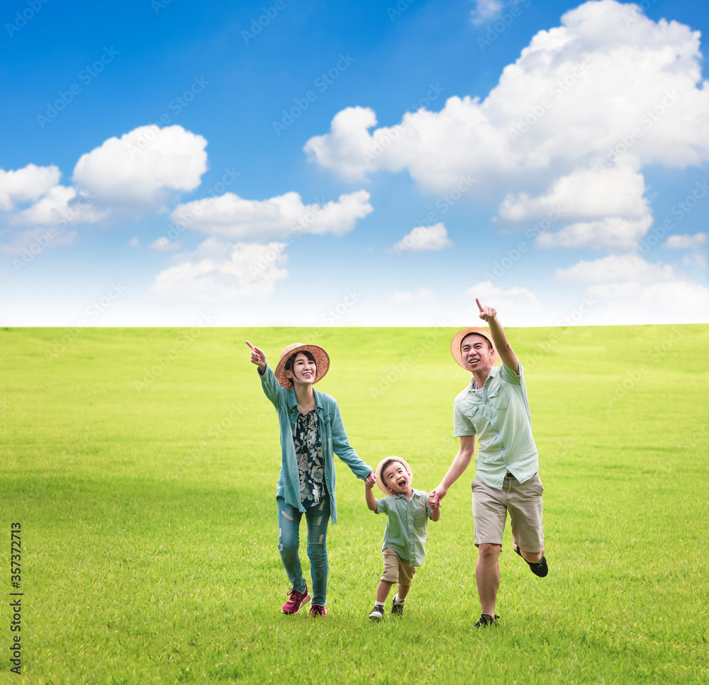 Happy family running together on the grass Happy family running together on the grass