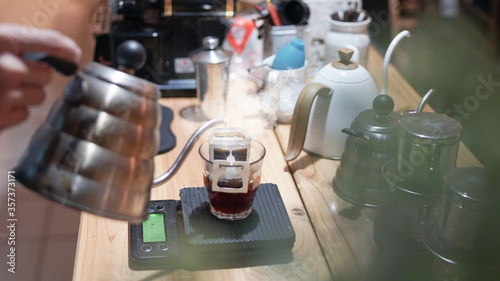 Drip brewing  filtered coffee  or pour-over is a method which involves pouring hot water over roasted  ground coffee beans contained in a filter  background.
