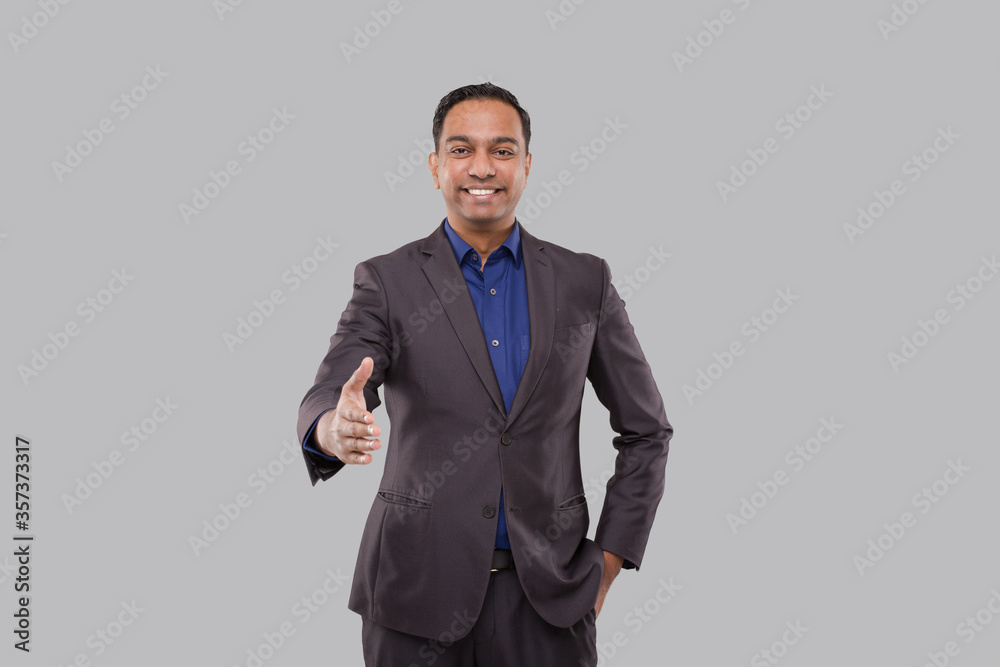 Indian Male Businessman offering hand to shake. Greeting and welcoming gesture. Business advertisement concept. Businessman Hand Shake Indian Male Businessman offering hand to shake. Greeting and welcoming gesture. Business advertisement concept. Businessman Hand Shake