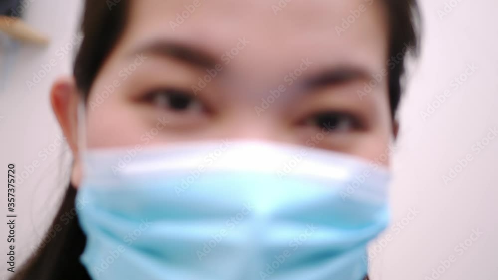 Beautiful Asian woman wearing a mask look camera and relaxing stay on the bed at home lifestyle and pleasure concept. Beautiful Asian woman wearing a mask look camera and relaxing stay on the bed at home lifestyle and pleasure concept.