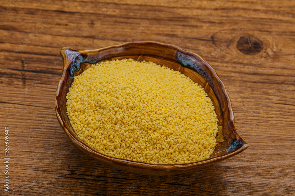 Raw cous cous heap in the bowl Raw cous cous heap in the bowl