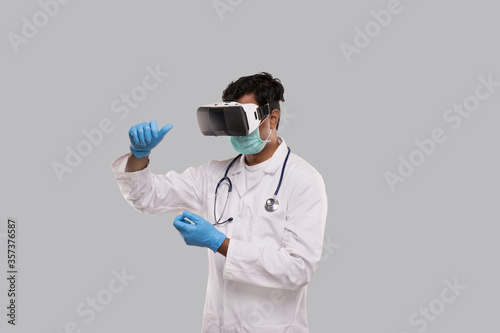 Doctor Wearing VR Glasses, Medical Mask and Gloves Hands in Front Isolated. Indian Man Doctor Holding in Virtual Reality