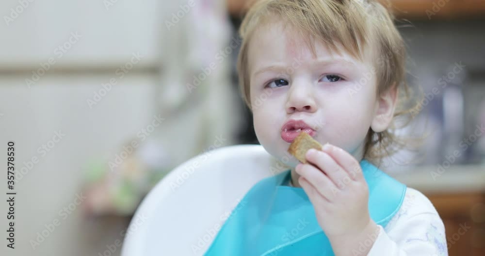 Boy eats lard and rusks Boy eats lard and rusks