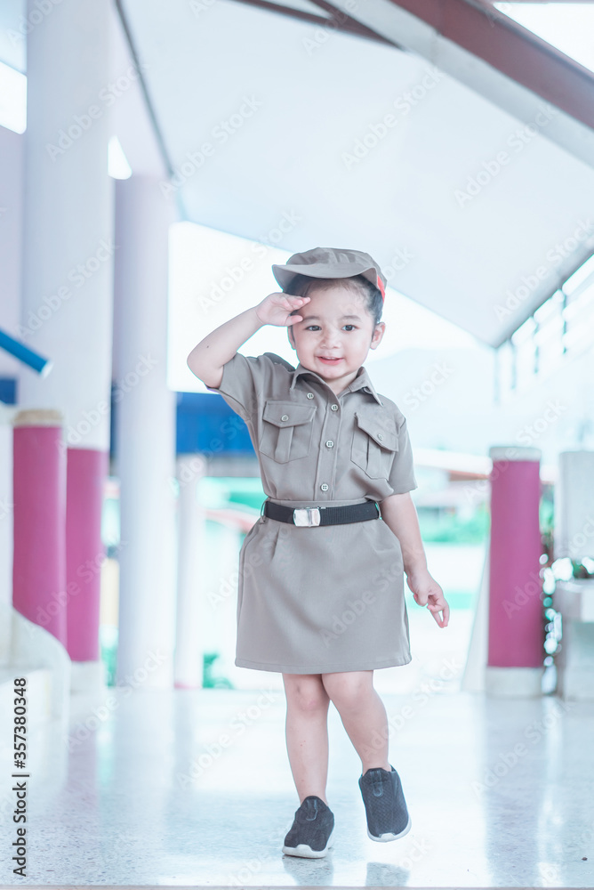 A Cute and lovely Asian baby girl in formal uniform dress A Cute and lovely Asian baby girl in formal uniform dress